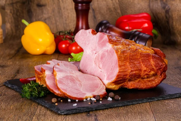 Smoked pork meat over the wooden background