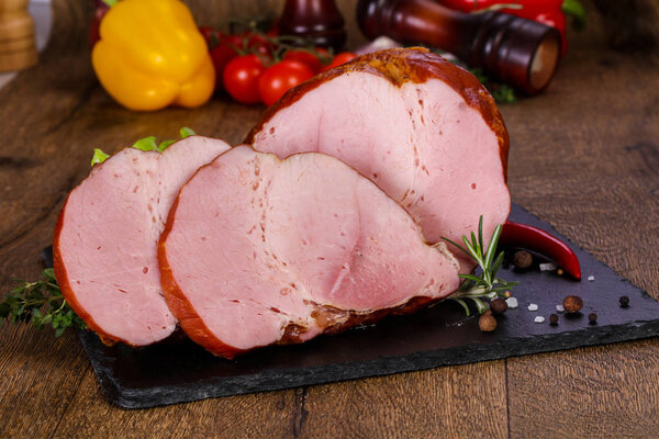 Smoked pork meat over the wooden background