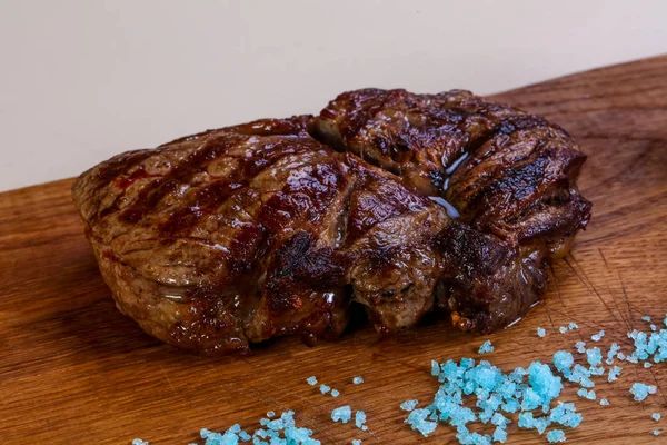 Grilled beef steak with sauce and blue salt