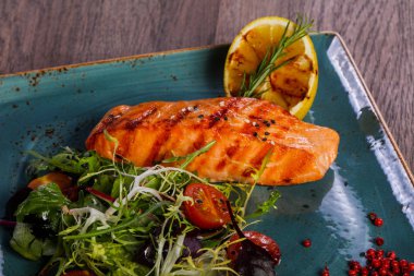 Limon ve salata ızgara somon bırakır