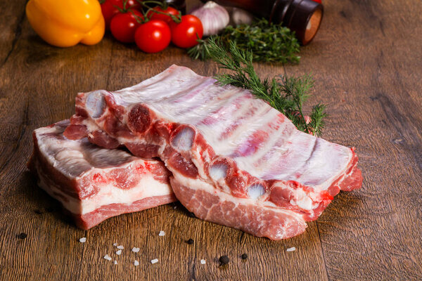Raw pork meat over wooden background
