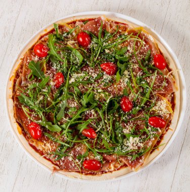 Hamon ve roka ile pizza.