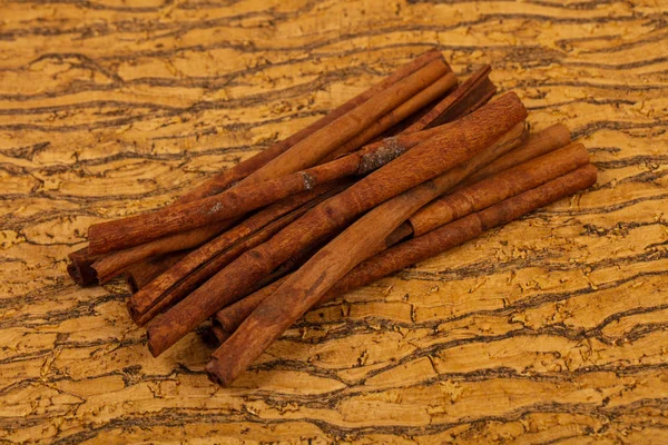 Aroma cinnamon sticks over the wooden background