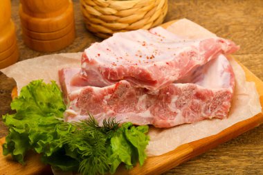 Çiğ domuz pirzolası pişmeye hazır. Baharatlı.