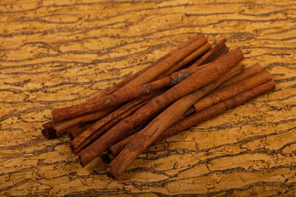 Aroma cinnamon sticks over the wooden background