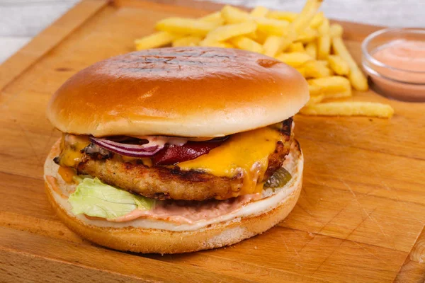 Burger with chicken, cheese, pepper, cucumbers and red onion