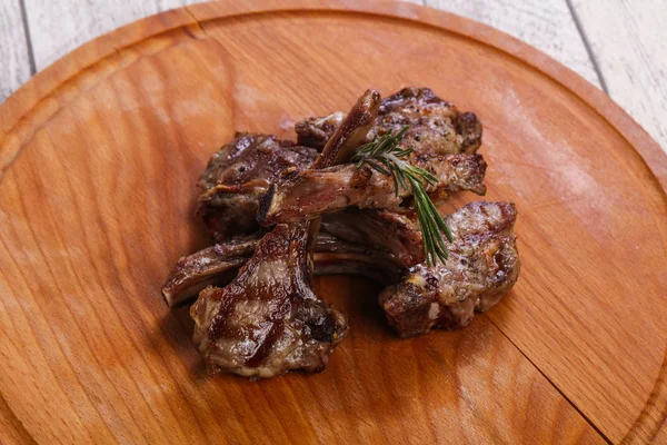 Grilled lamb with rosemary over the wooden board