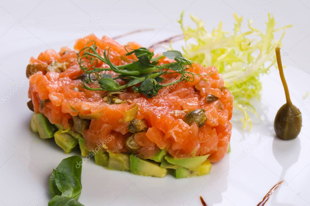 Tartar with salmon and avocado served capers and balsamico