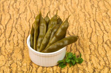 Pickled green bean heap in the bowl clipart
