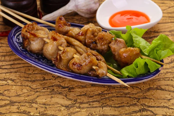 Chicken skin skewer with chili sauce