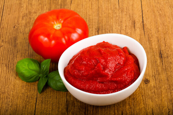 Tomato paste with basil leaves
