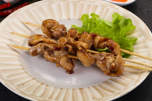 Chicken skin skewer with chili sauce