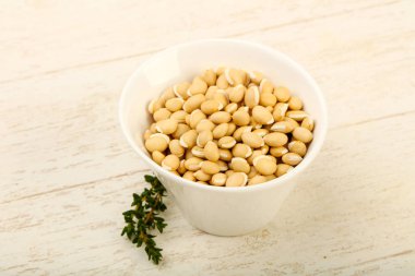 Kase ahşap arka plan üzerinde çiğ beyaz fasulye