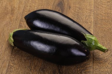 Raw ripe eggplant ready for cooking  clipart