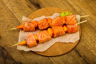 Pişmeye hazır baharatlı çiğ somon şişi.