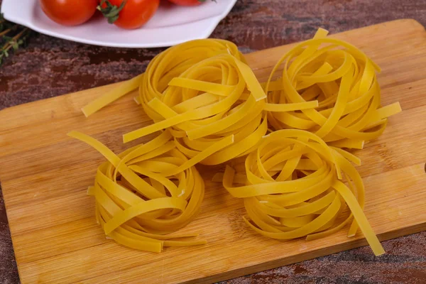 Raw pasta fettuccini — Stock Photo, Image