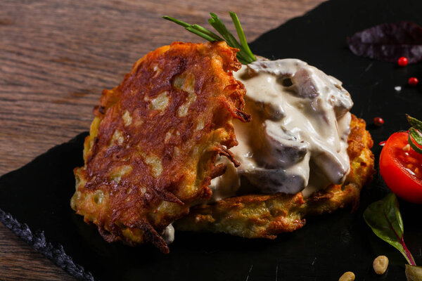 Potato cakes with meat served tomato
