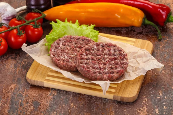 Raw burger cutlet ready for grill