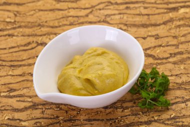 Mustard sauce in the bowl served parsley