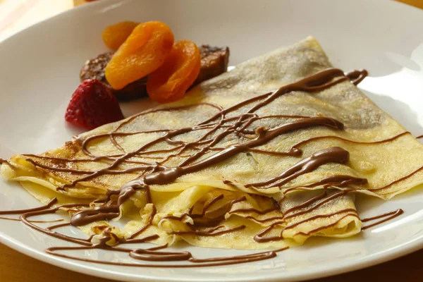 Pancake with chocolate and fruits — Stock Photo, Image