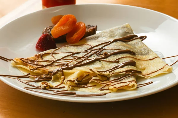 Pancake with chocolate and fruits — Stock Photo, Image