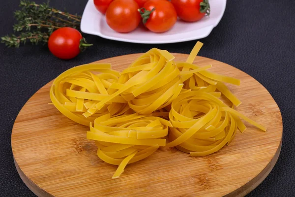 Raw pasta fettuccini — Stock Photo, Image