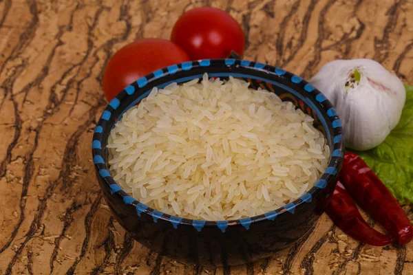 Raw uncooked rice in the bowl — Stock Photo, Image