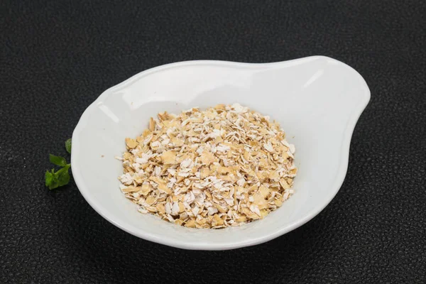 Raw oats in the bowl — Stock Photo, Image