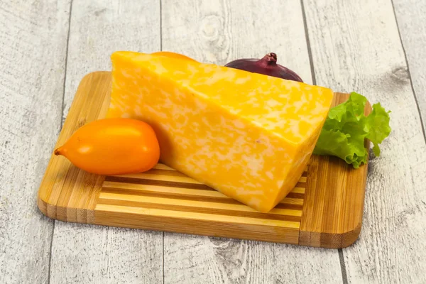 Marble cheese  triangle over wooden