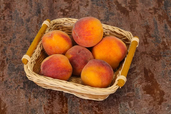 Peach heap in the wooden basket — Stock Photo, Image