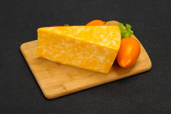 Triângulo de queijo de mármore sobre madeira — Fotografia de Stock