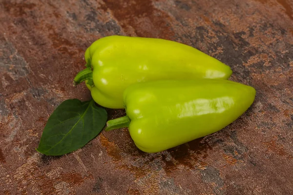 Green bell pepper over wooden background