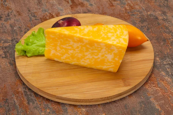 Marble cheese  triangle over wooden