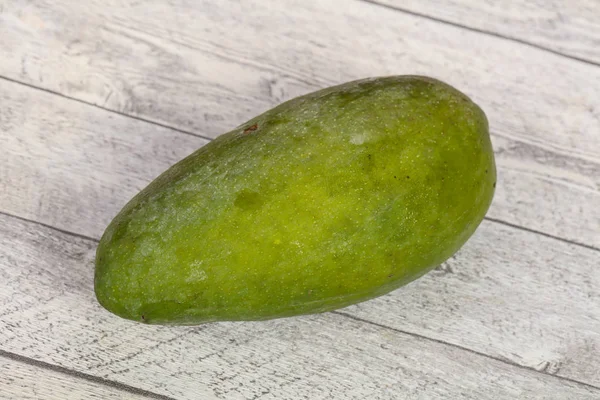 Green tasty mango over wooden background — Stock Photo, Image