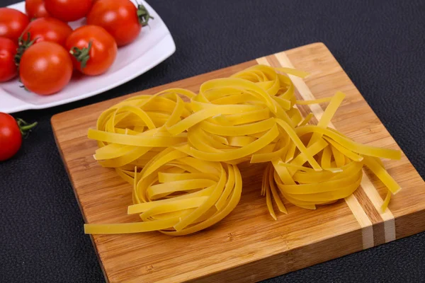 Raw pasta fettuccini — Stock Photo, Image