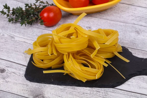 Raw pasta fettuccini — Stock Photo, Image