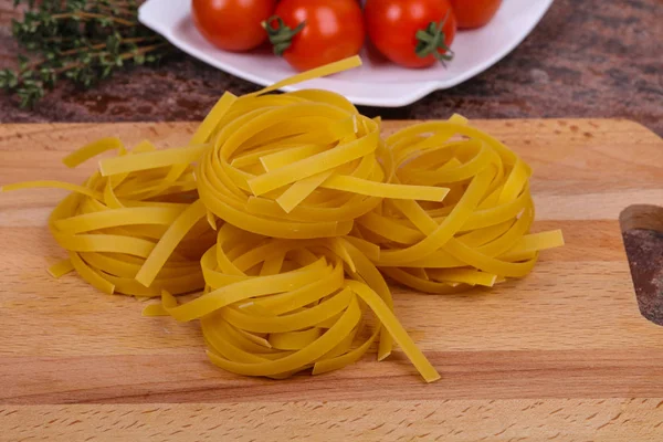 Raw pasta fettuccini — Stock Photo, Image