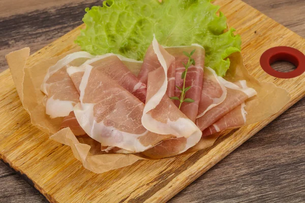 Italian prosciutto pork meat over board — Stock Photo, Image