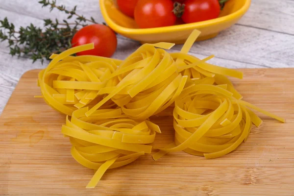 Raw pasta fettuccini — Stock Photo, Image