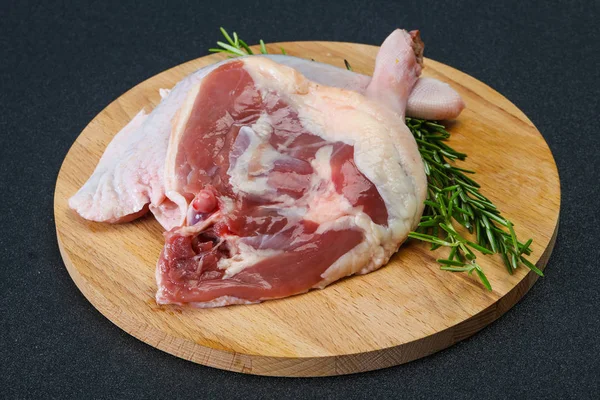 Raw duck leg served rosemary — Stock Photo, Image