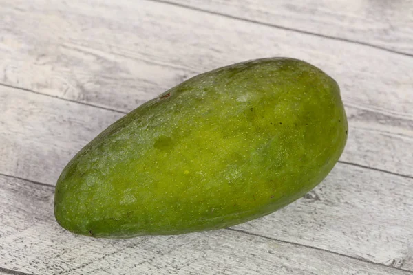 Green tasty mango over wooden background — Stock Photo, Image