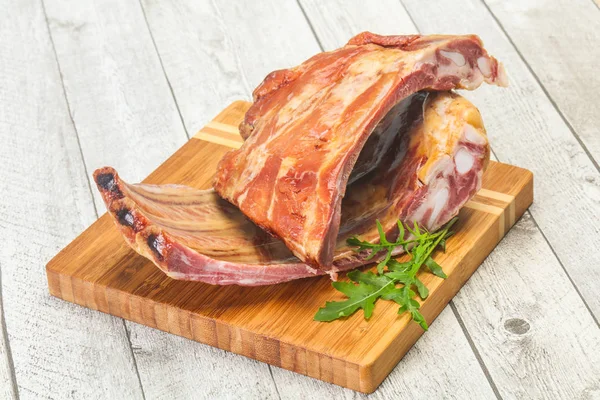 Smoked pork ribs over the wooden background — Stock Photo, Image