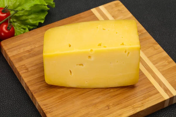 Hard yellow tasty cheese brick — Stock Photo, Image