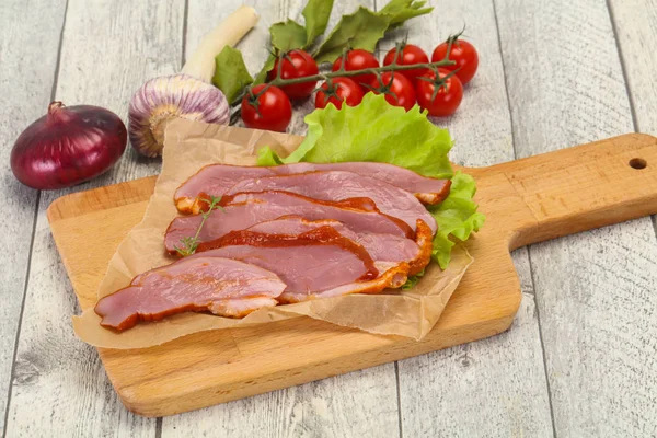 Sliced smoked duck breast served salad