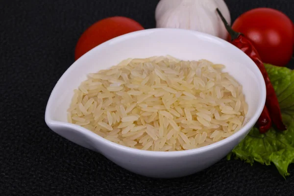 Raw uncooked rice in the bowl — Stock Photo, Image