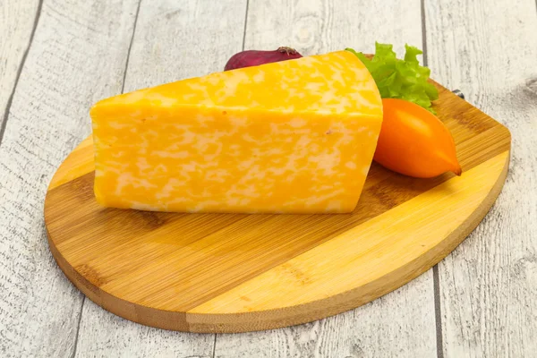 Marble cheese  triangle over wooden