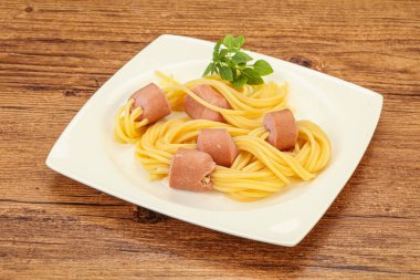 Çocuklar sosisli ve fesleğenli makarna.