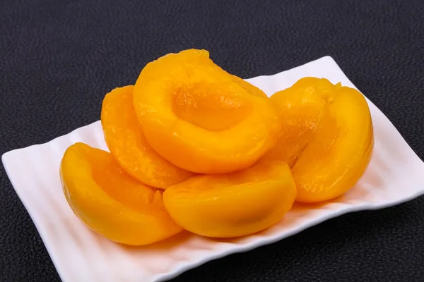 Sweet marinated peach slices in the bowl