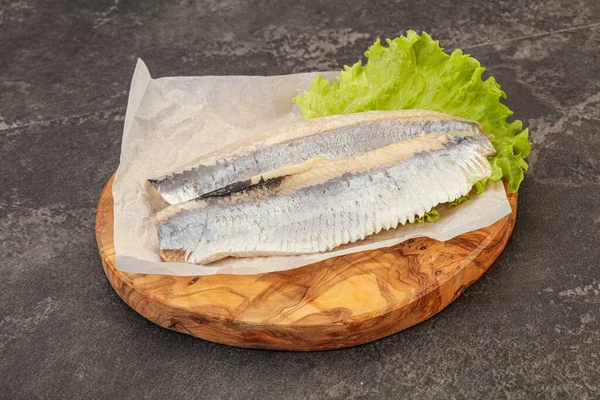 Herring fillet with salad leaves over board — Stock Image Herring Fillet Salad Leaves Board Stock Photo