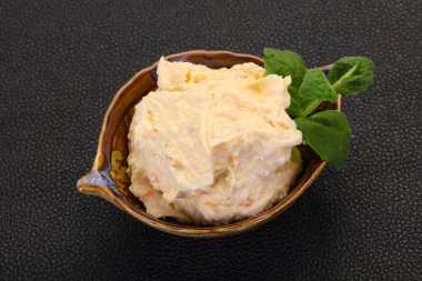 Nane yaprağı servis edilmiş kayısı ile kaymak.